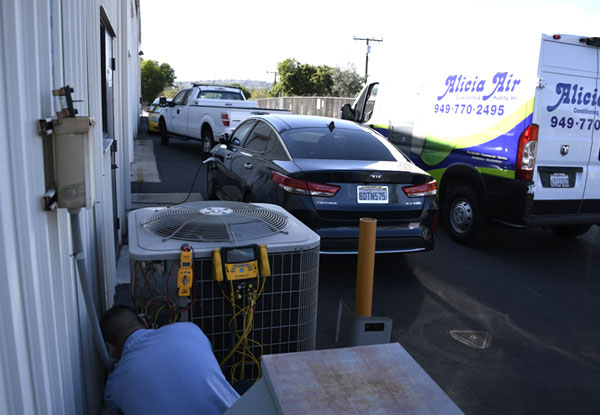 Servicing a condenser beside the van