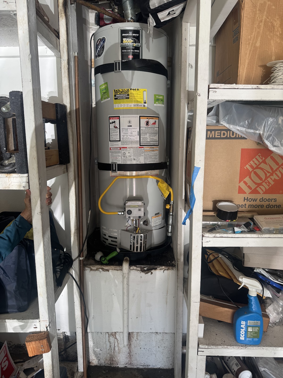 A tank water heater swapped in a tight closet