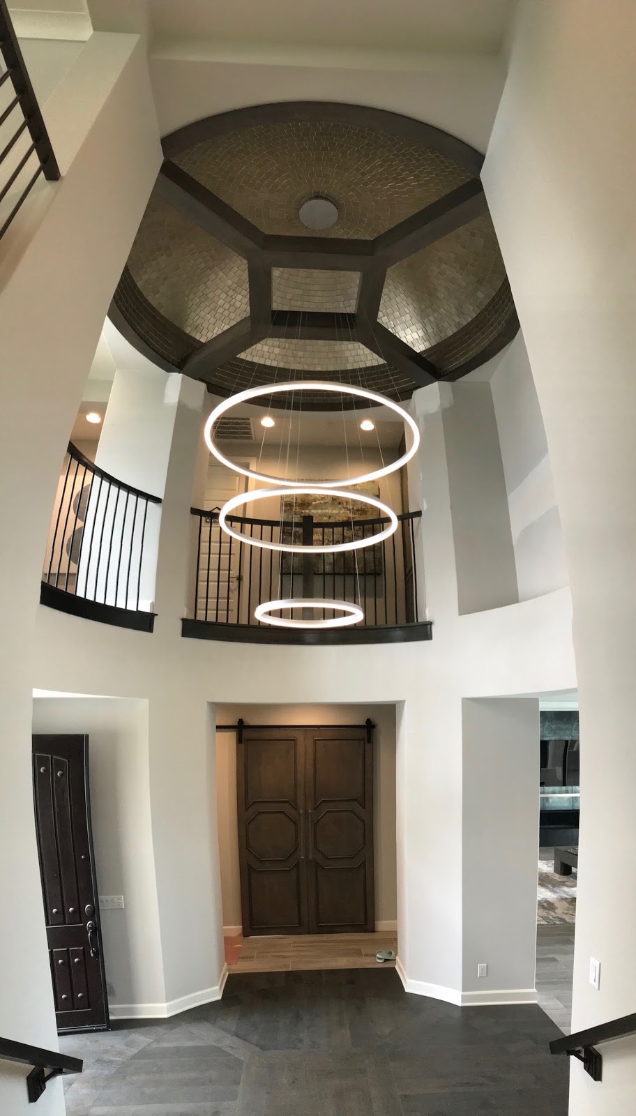 Three suspended LED rings, two-story entryway