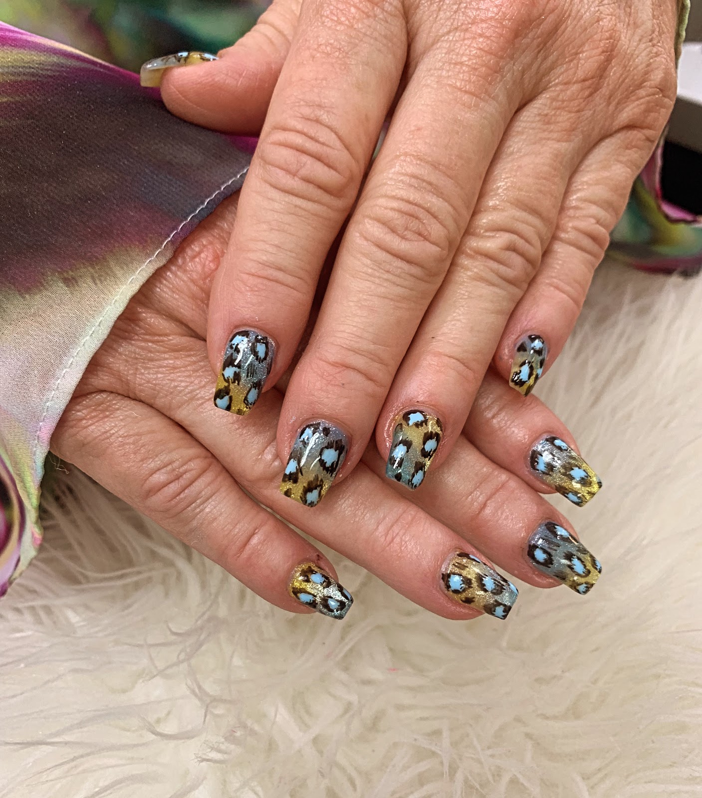 Square nails with gold and grey leopard print and pale blue accents, glossy finish, at B&T Nails