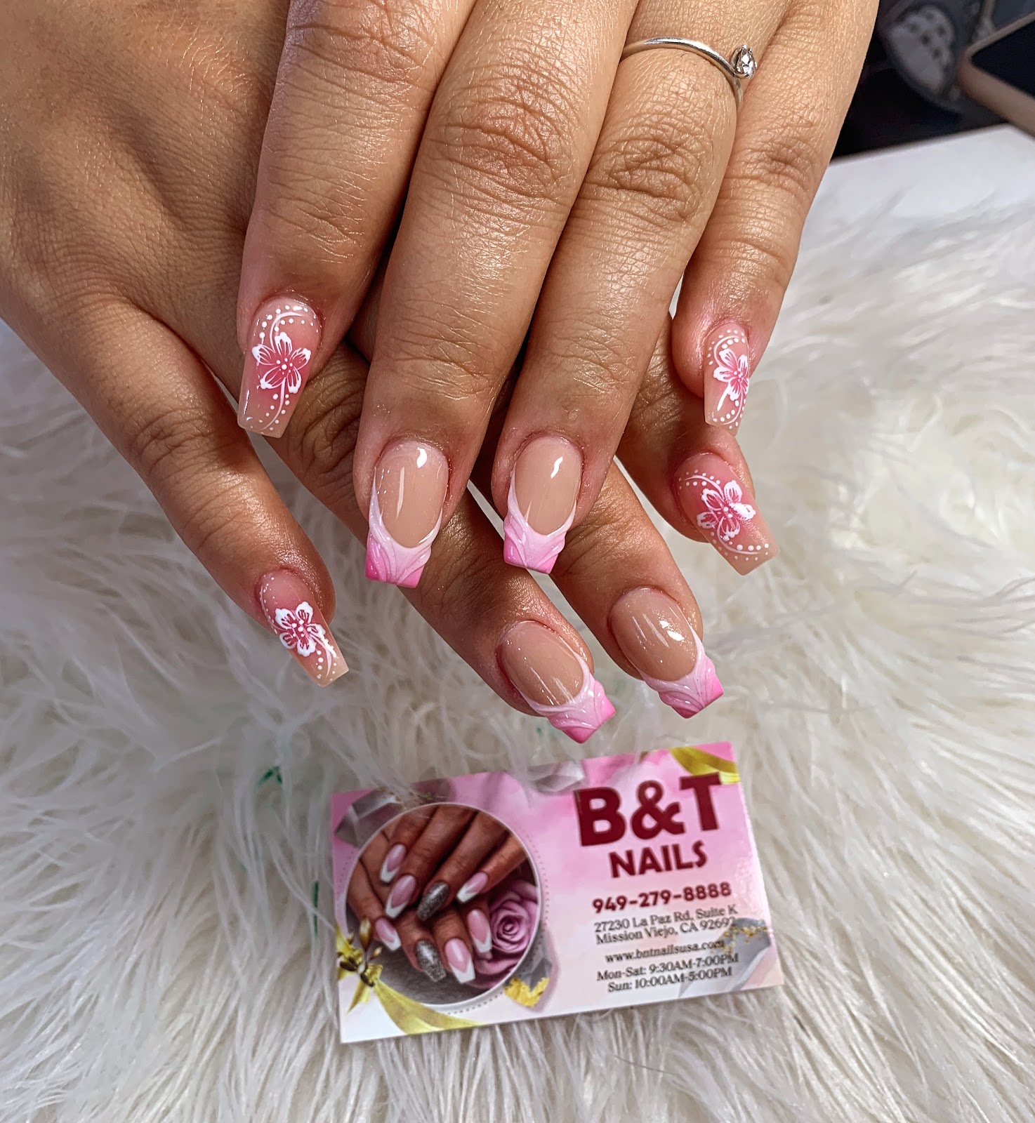 Pink ombre French nails with freehand floral art at B&T Nails