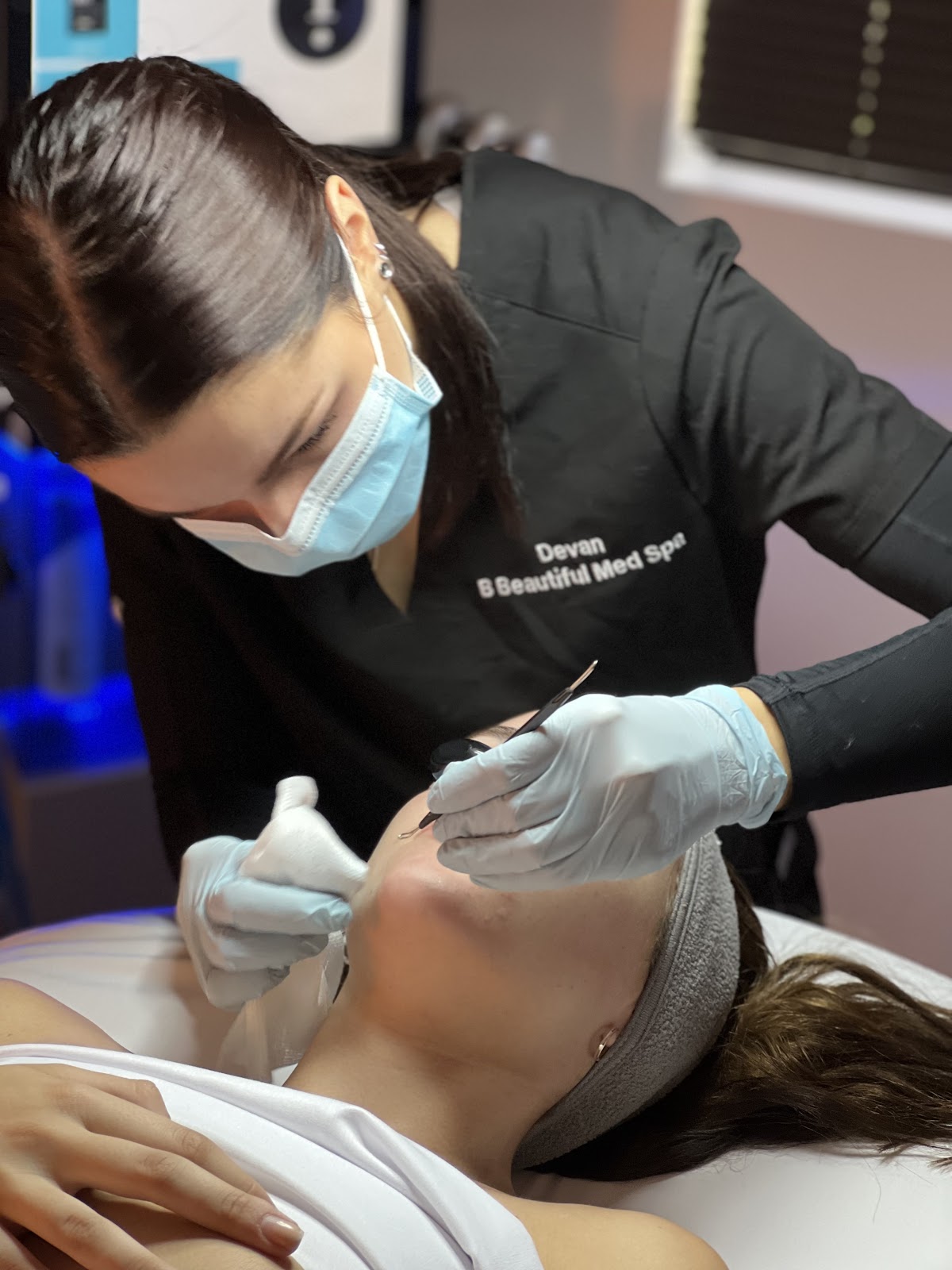 An esthetician at B Beautiful Med Spa performing a treatment