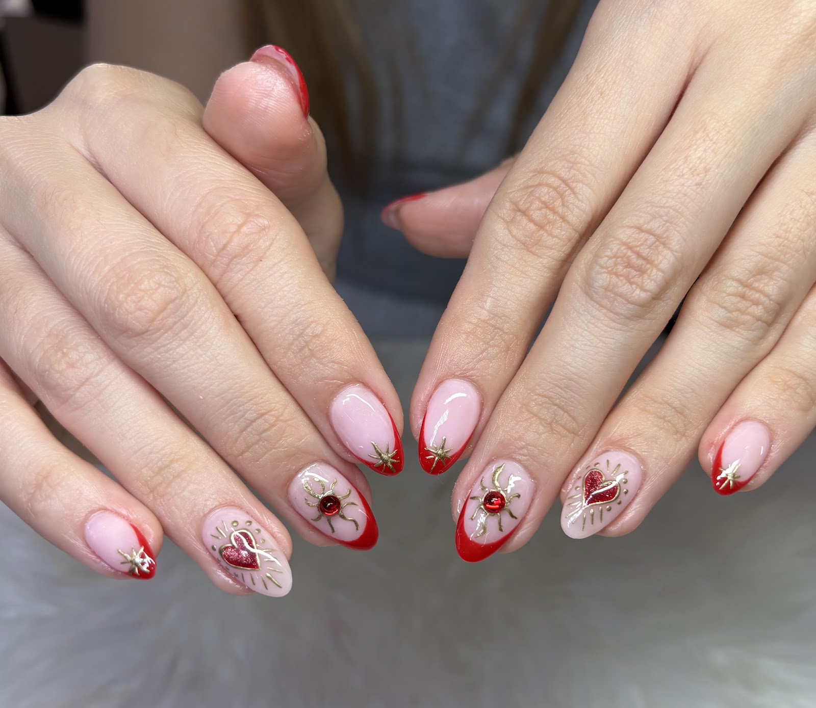 Nail art at Blooming Nails: Red French with gold and gems