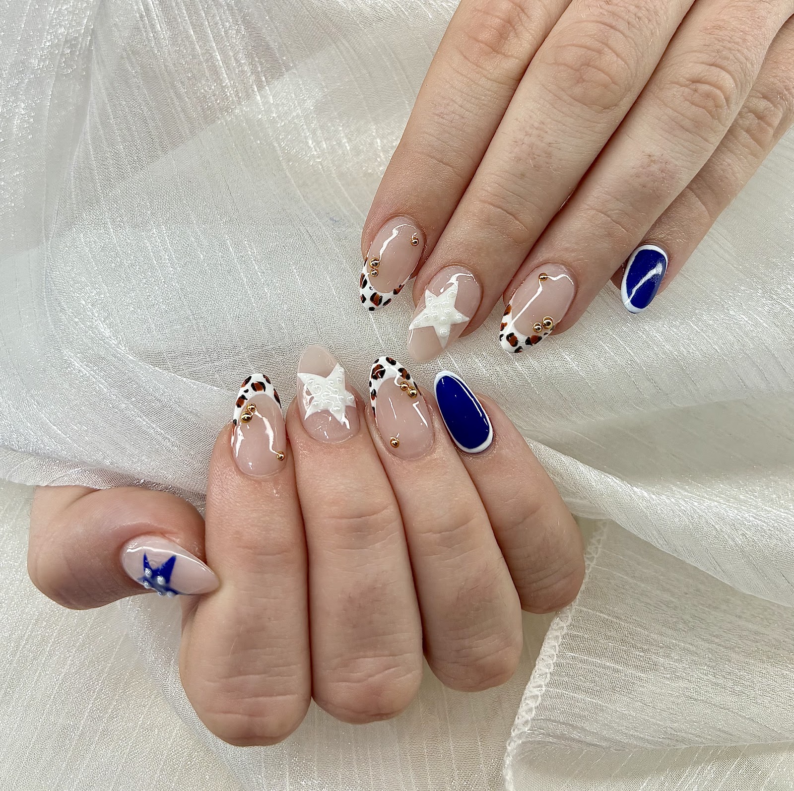 Nail art at Blooming Nails: Navy and nude with white stars