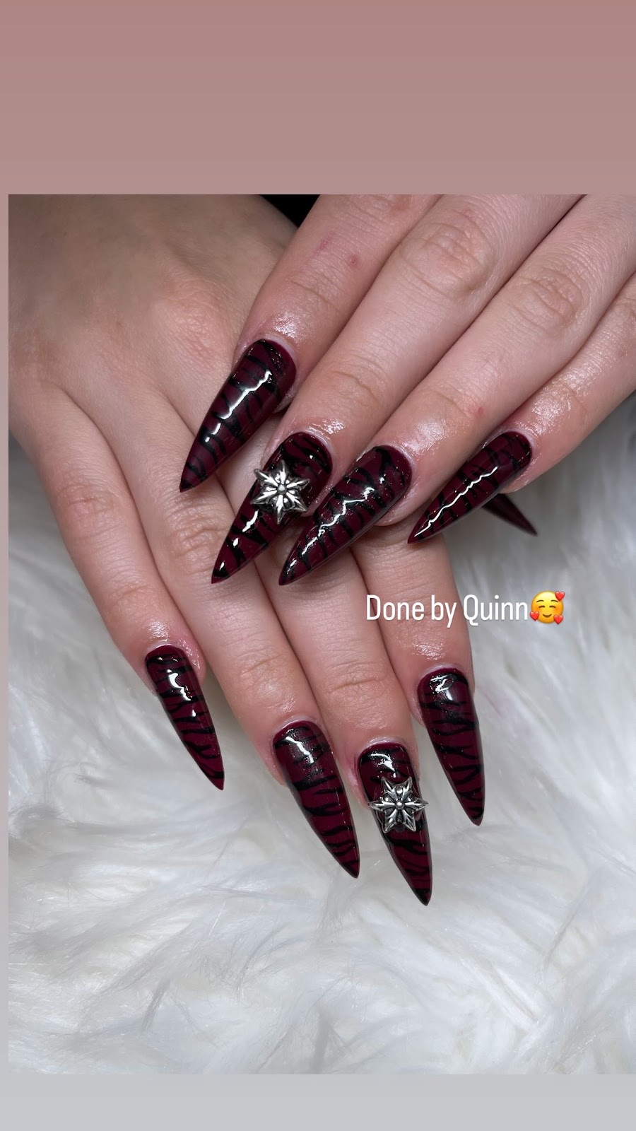 Nail art at Blooming Nails: Deep burgundy stiletto, star charms