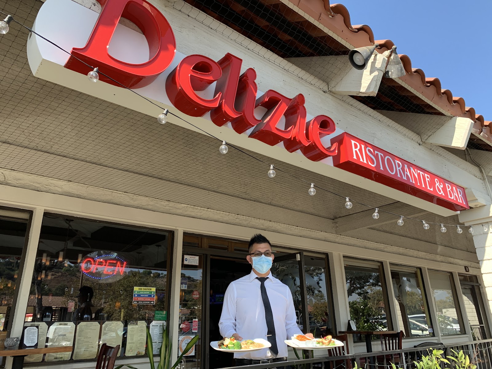 The Delizie storefront on Marguerite Parkway at dusk