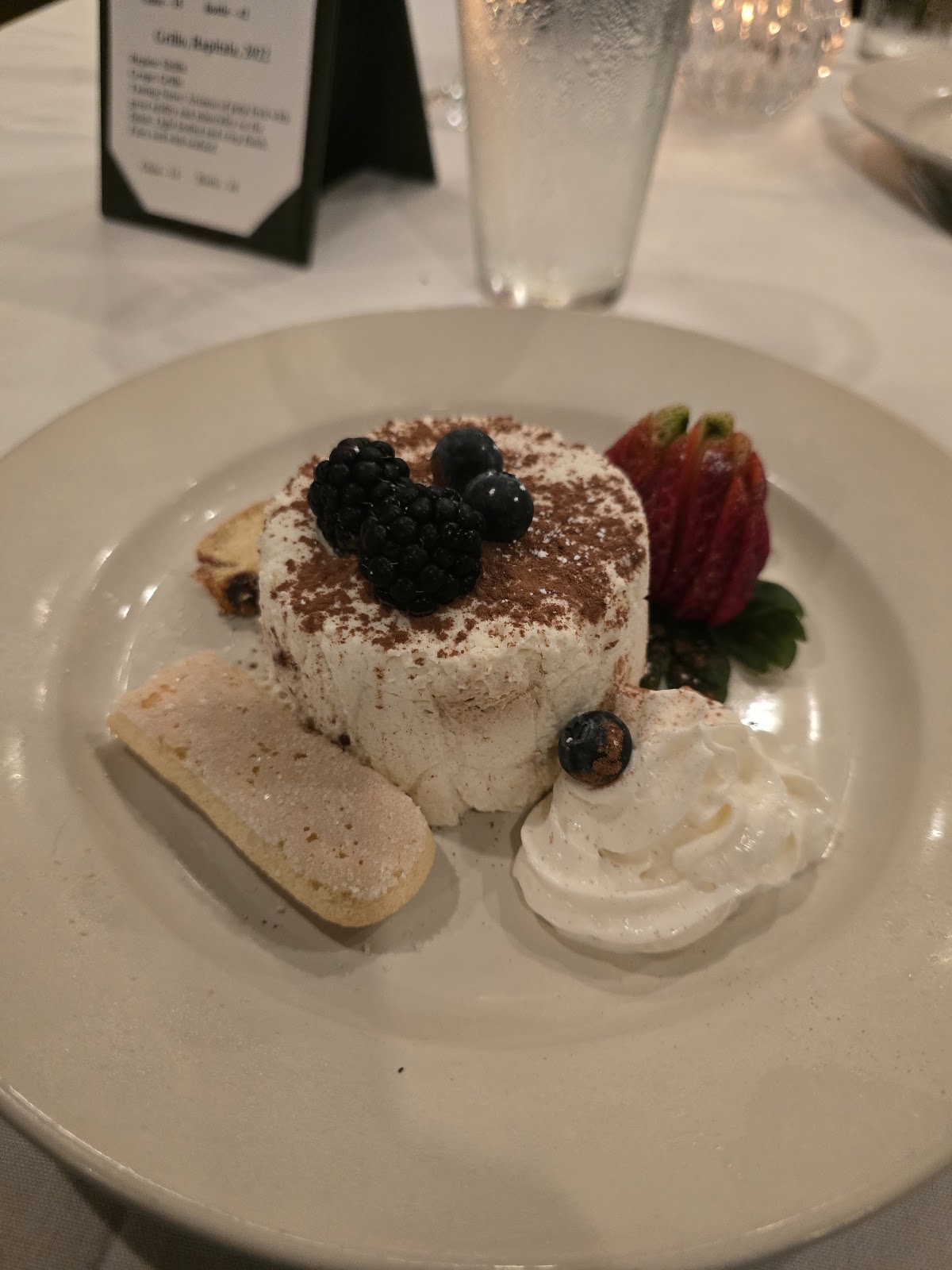House-made tiramisù with berries and dusted cocoa at Delizie