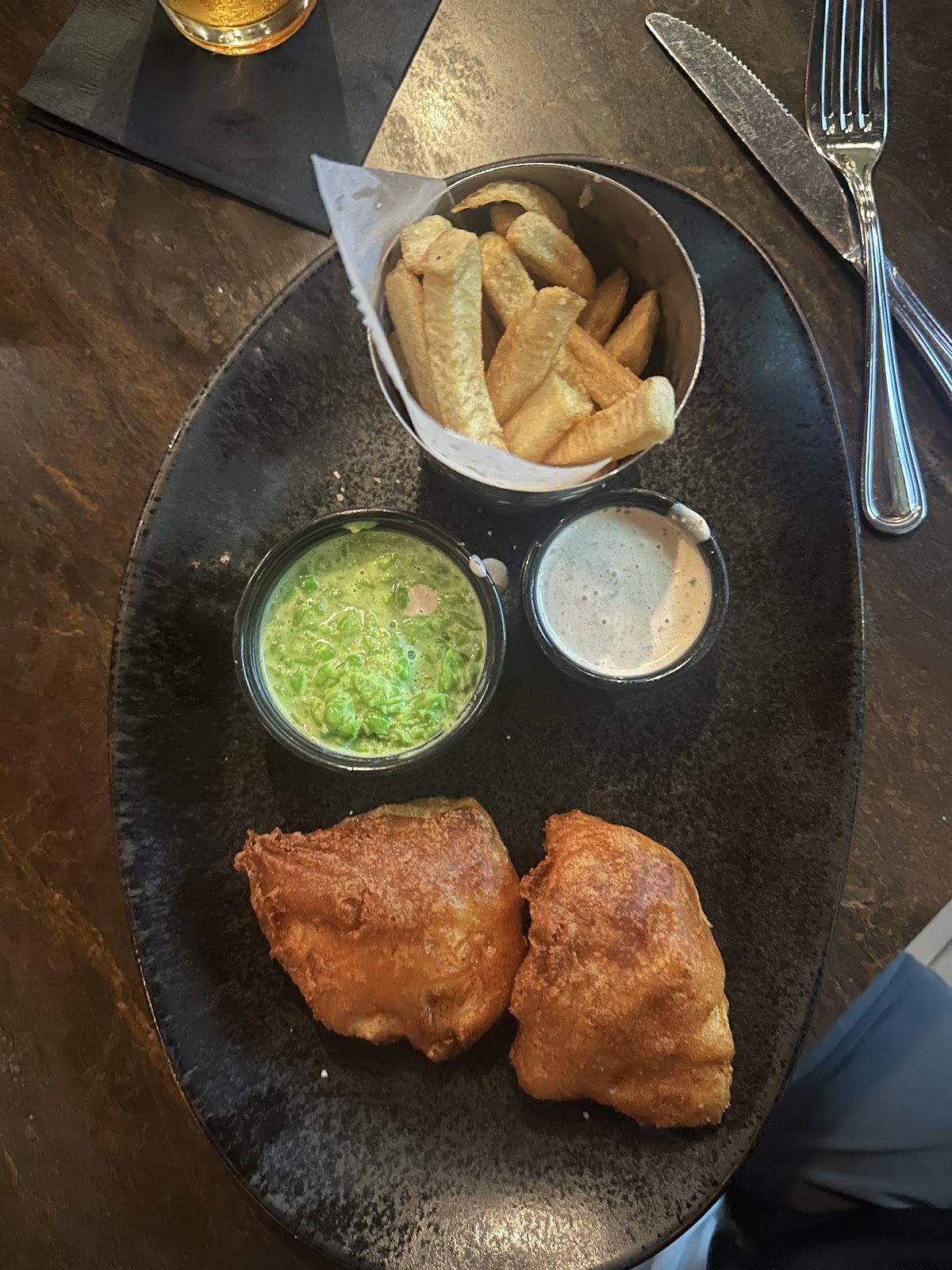 Fish & Chips at Dublin 4 Gastropub. Beer battered North Atlantic cod, crushed garden peas, sea salt and malt vinegar hand-cut fries.