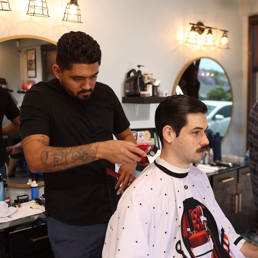 A barber at work at EMS Barbershop