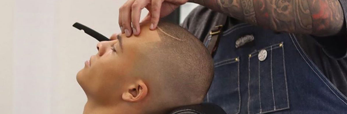 Bald skin fade finished with a straight razor at Faint Blends Barbershop