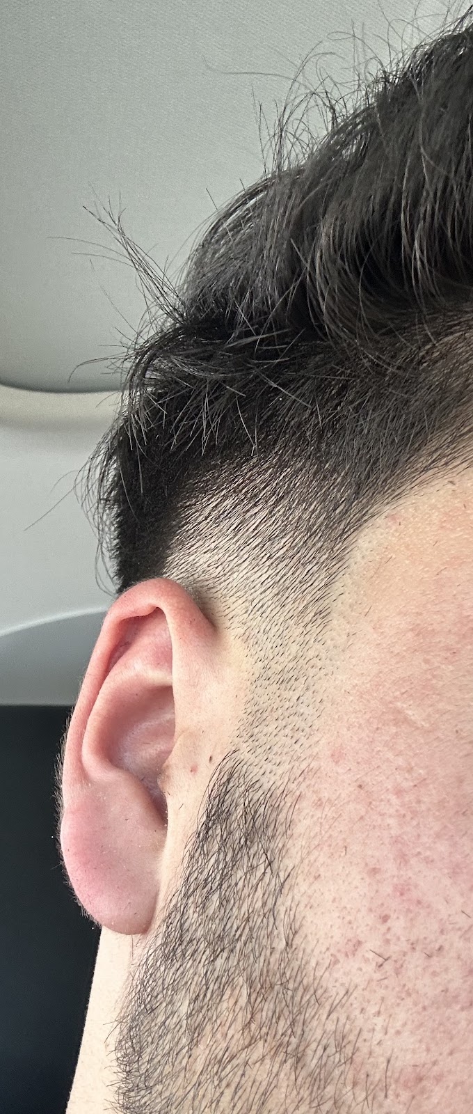 Mid fade and clean beard line-up, side profile, at Faint Blends Barbershop