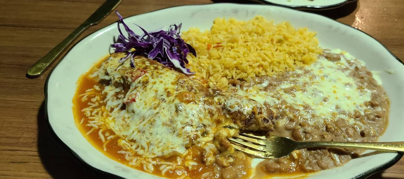 A combination plate of carne asada, rice and beans