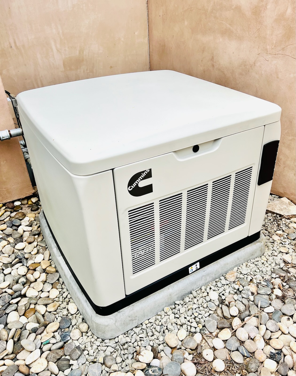 Cummins residential standby generator set on a concrete pad by Gerhard Electric