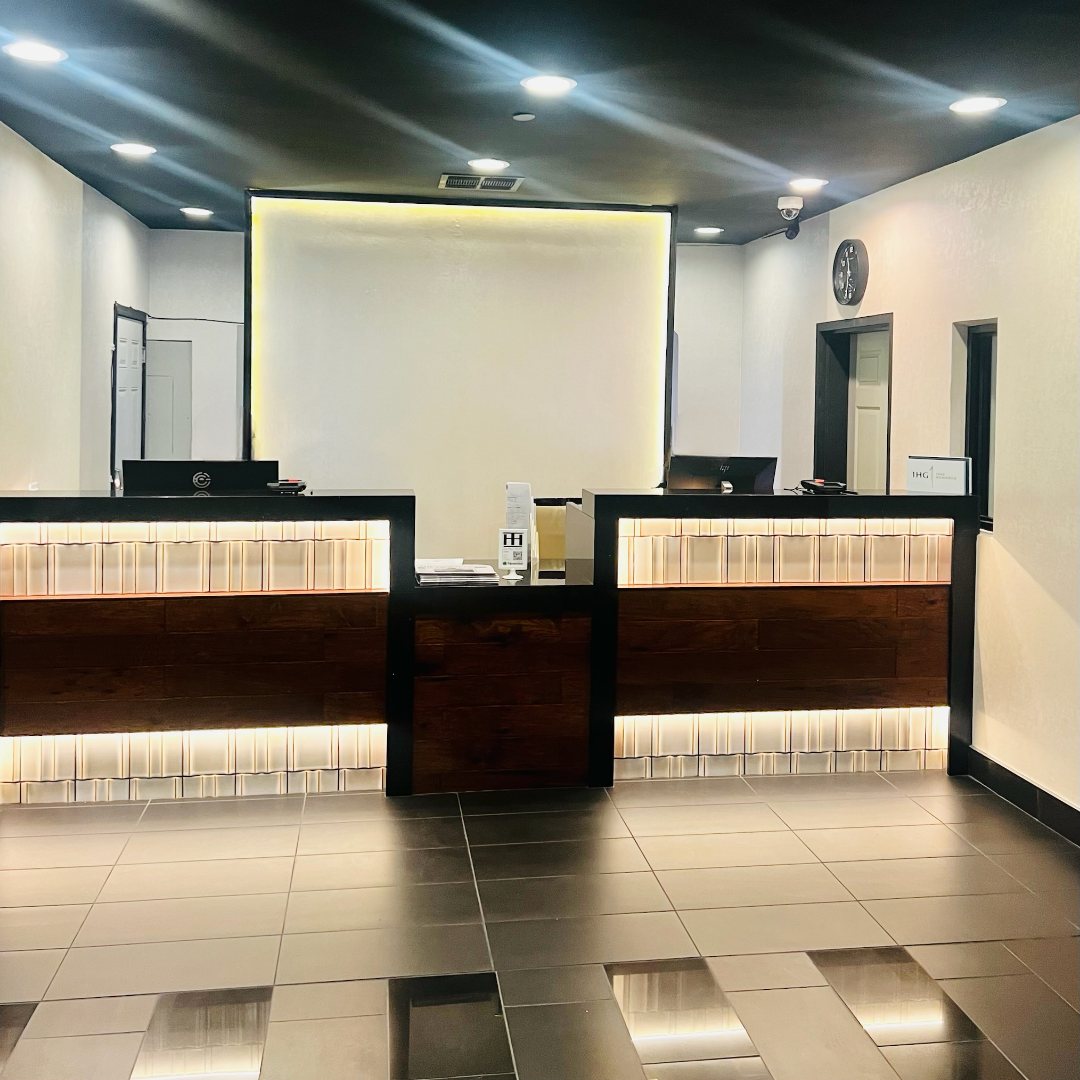 Hotel front-desk lobby with recessed and cove lighting installed by Gerhard Electric