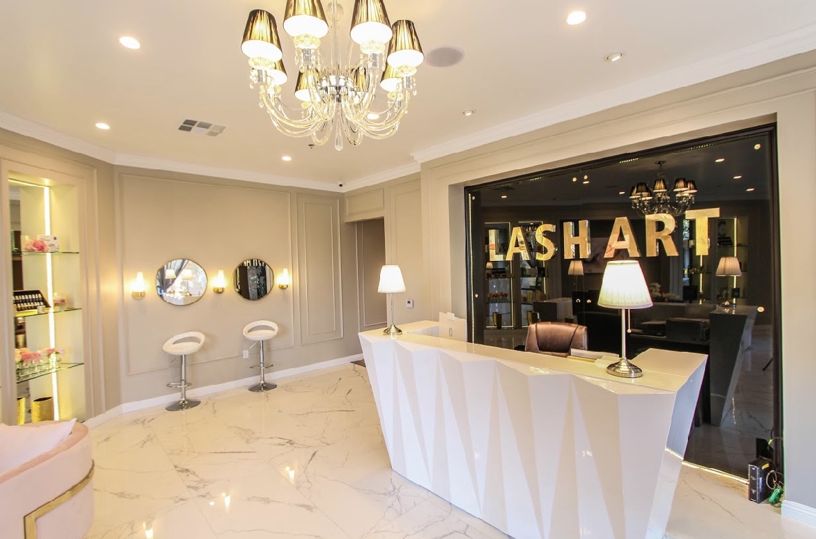 Inside Hello Bailey: chandelier-lit reception with the LASH ART signage, Mission Viejo