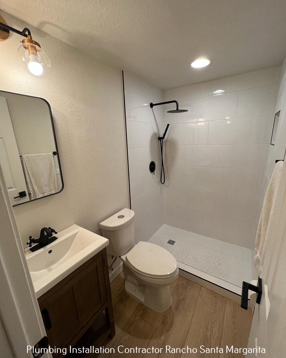 Finished bath remodel, white tile and matte-black fixtures