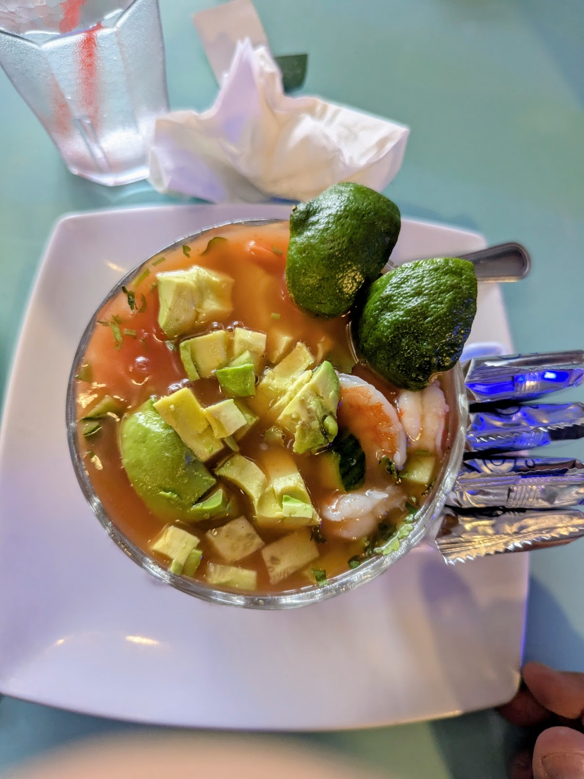 Coctel de camarones at La Cocina de Ricardo: a shrimp cocktail in a glass with diced avocado, cilantro and lime in a tomato cocktail broth