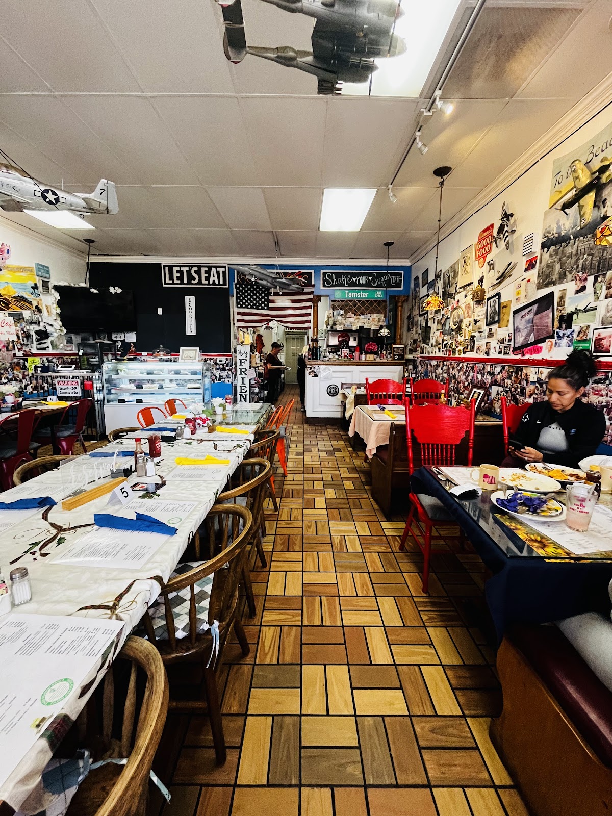 The cozy retro interior of Laguna Cafe with checkerboard floor and memorabilia
