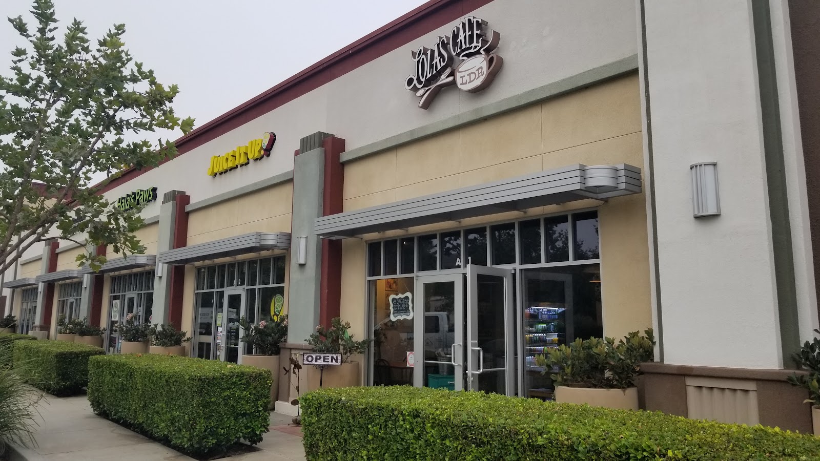 The storefront of Lola's Cafe in the Ladera Ranch shopping center off Corporate Drive