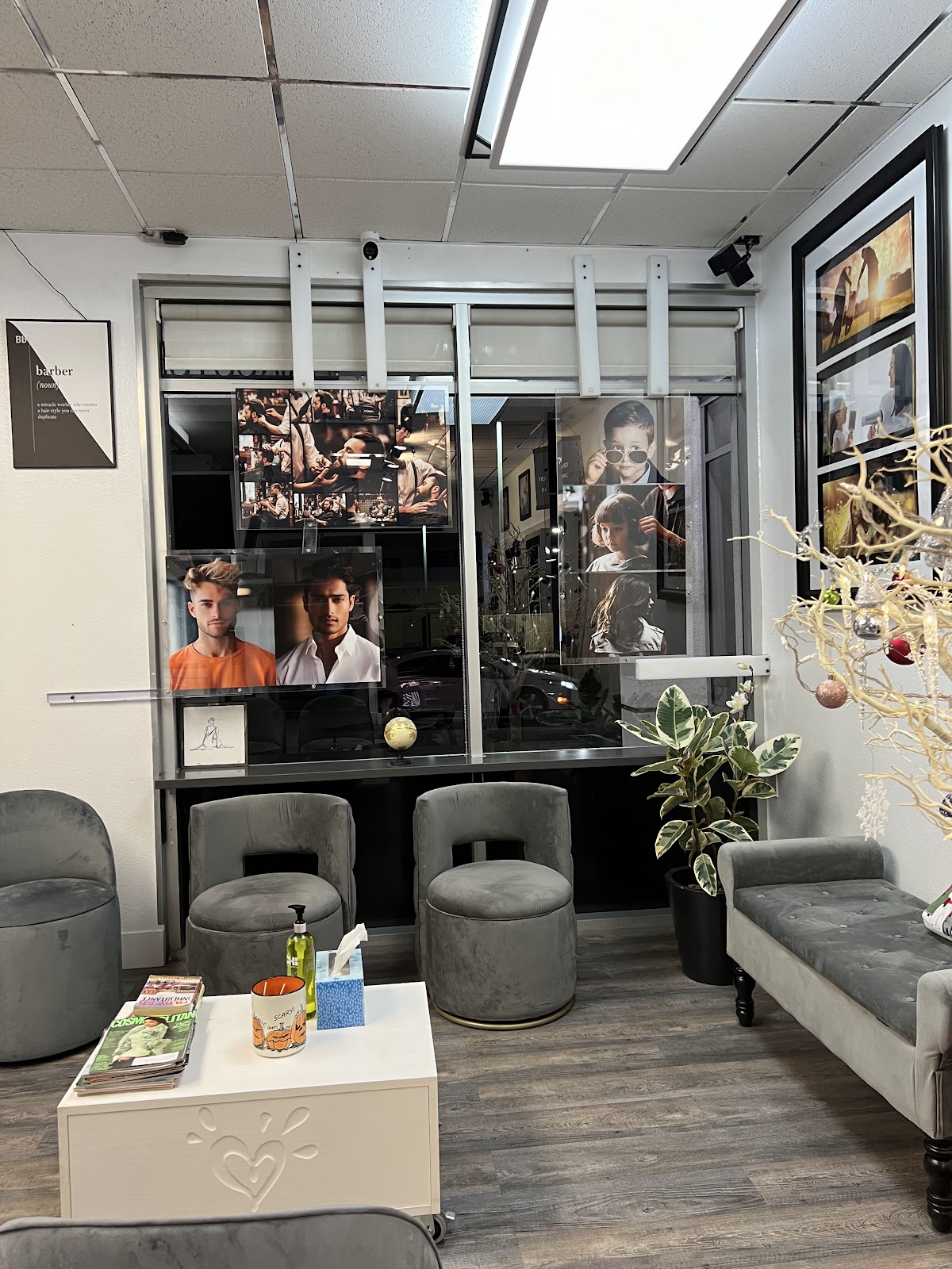 The Maia Bella waiting area: gray velvet stools, magazines on a low table, a wall of framed prints