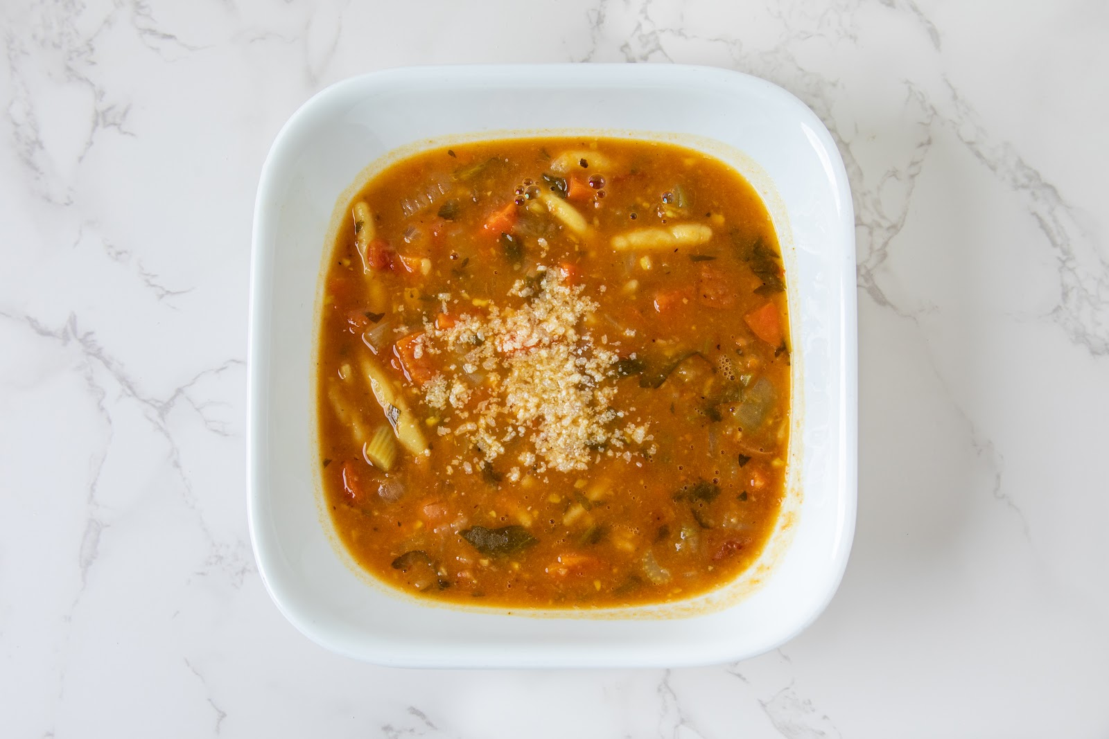 Minestrone at Mangi Con Amore. Tomato base, ditalini, vegetables from the morning prep, a grating of parmigiano on top.