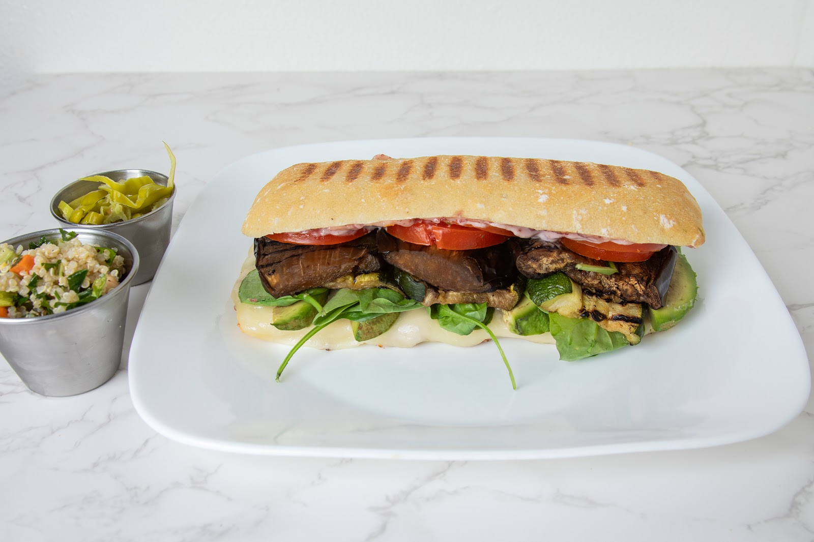 Vegetariano alla Griglia at Mangi Con Amore. Grilled eggplant, zucchini, fresh spinach, tomato, melted mozzarella, on ciabatta. Pressed until everything settles into the bread.
