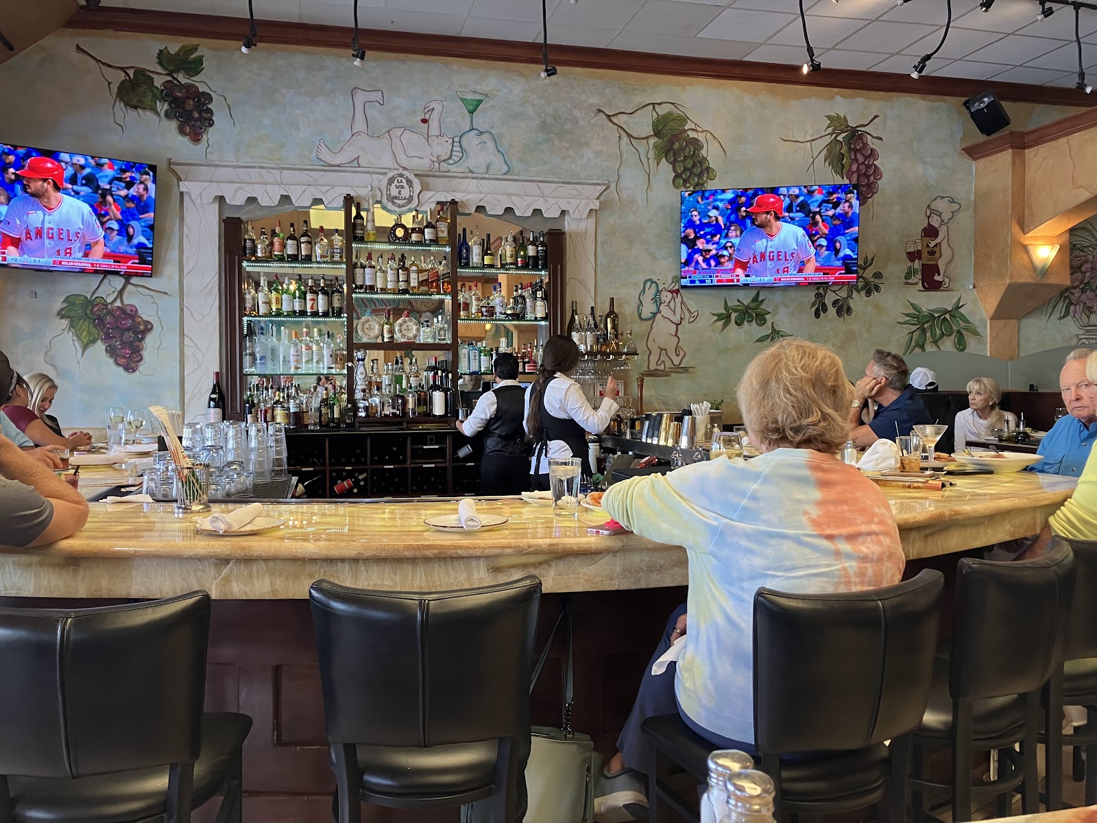 The full bar at Mangia Bene with warm wood and seating