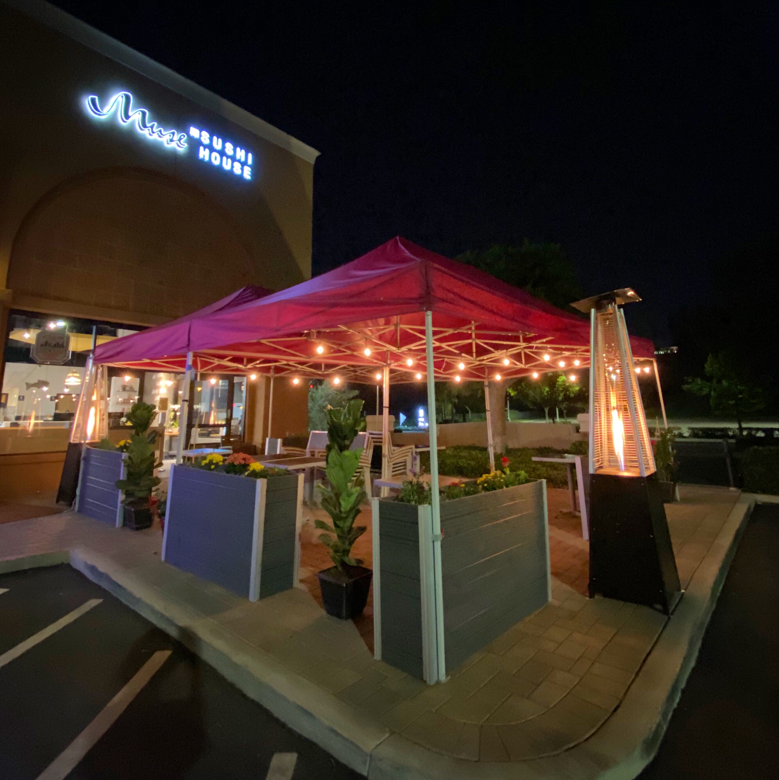 Muse Sushi House at night, neon sign glowing over a string-lit patio in Laguna Niguel