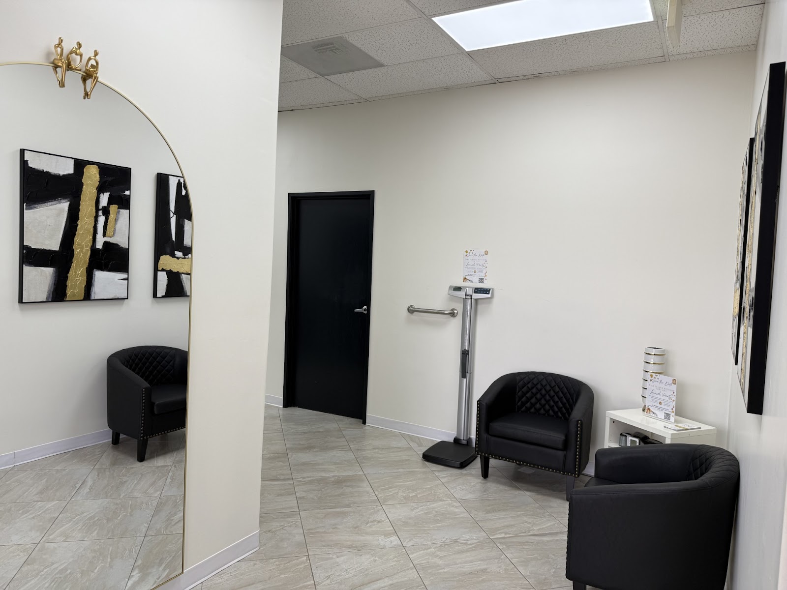 The bright OC Weight Loss & Med Spa lounge with a gold arch mirror