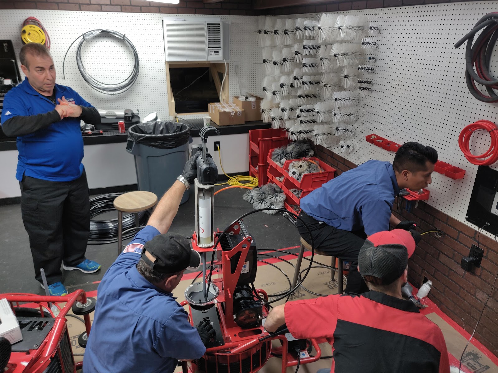 The Patriot Plumbing crew working on drain equipment in their shop
