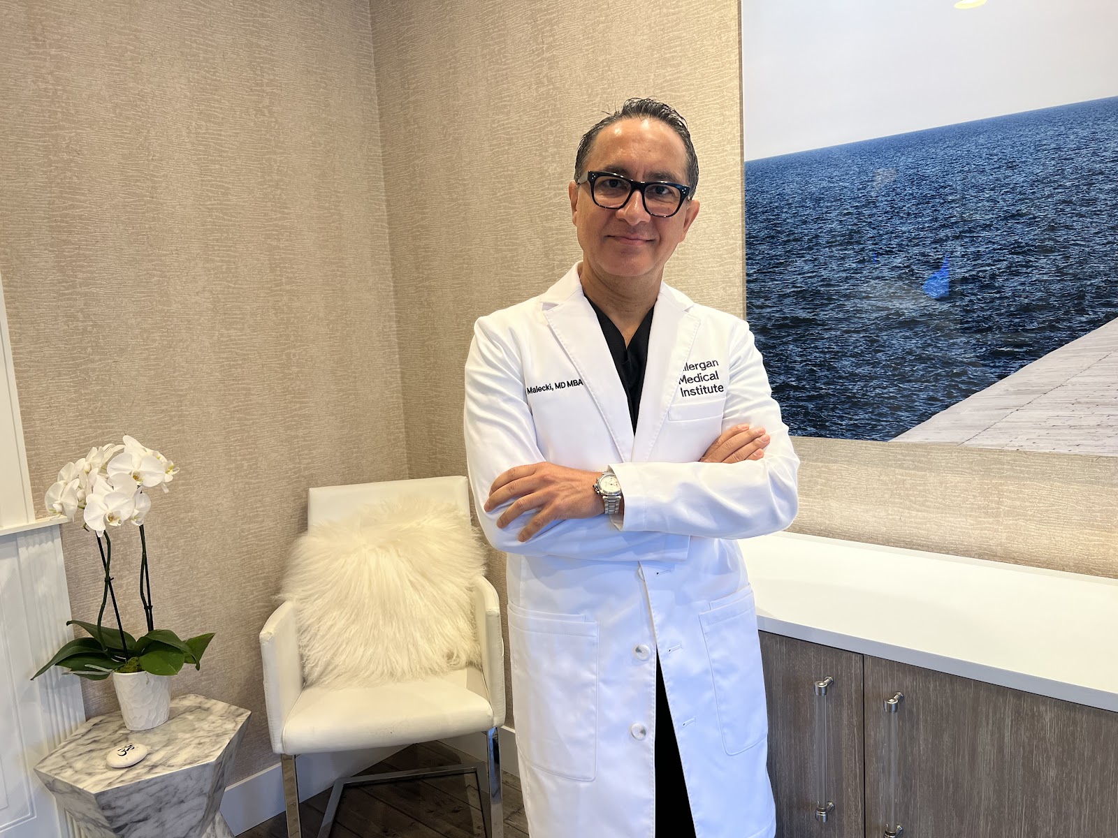 Dr. Malecki, MD, MBA, in his white coat at Platinum Medical Spa