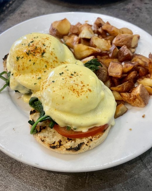 Avocado eggs benedict at Plumeria Cafe, with country potatoes