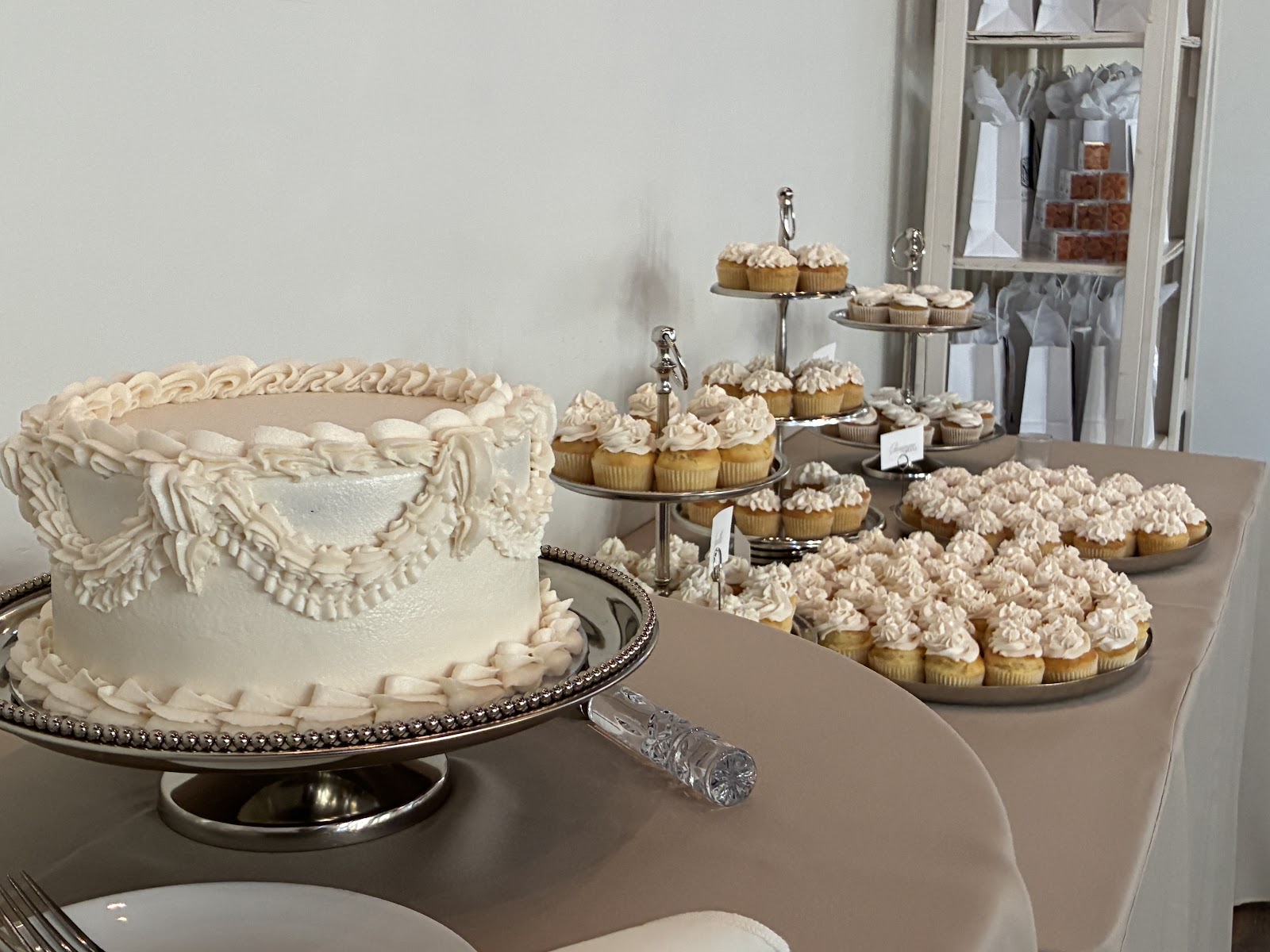 An elegant cake and cupcake dessert display