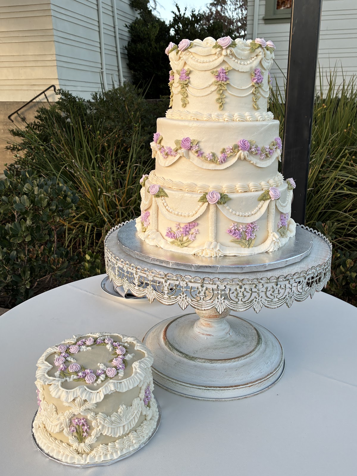 A lace-detailed cake with fresh flowers