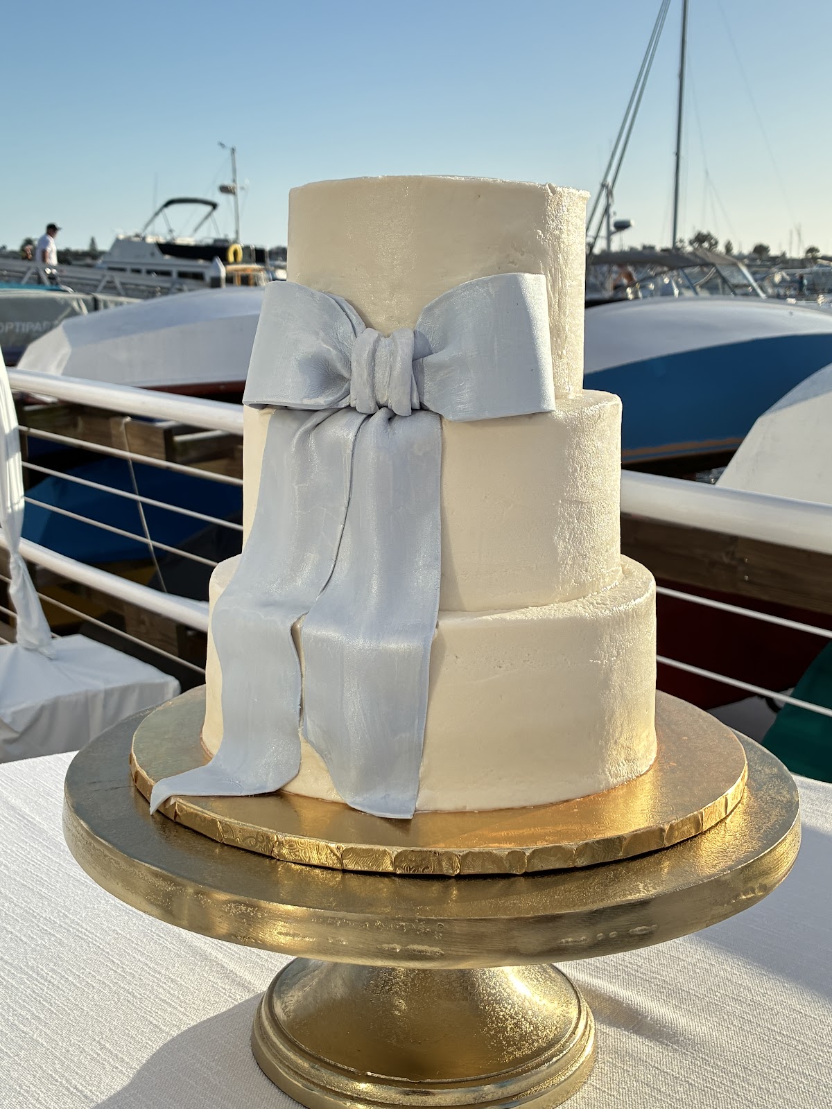 A tiered white cake finished with a delicate bow