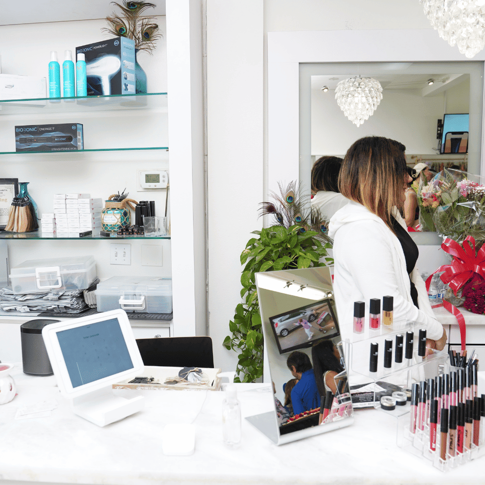 Inside Pretty Threading: counter and brow station with stylist at work, Mission Viejo