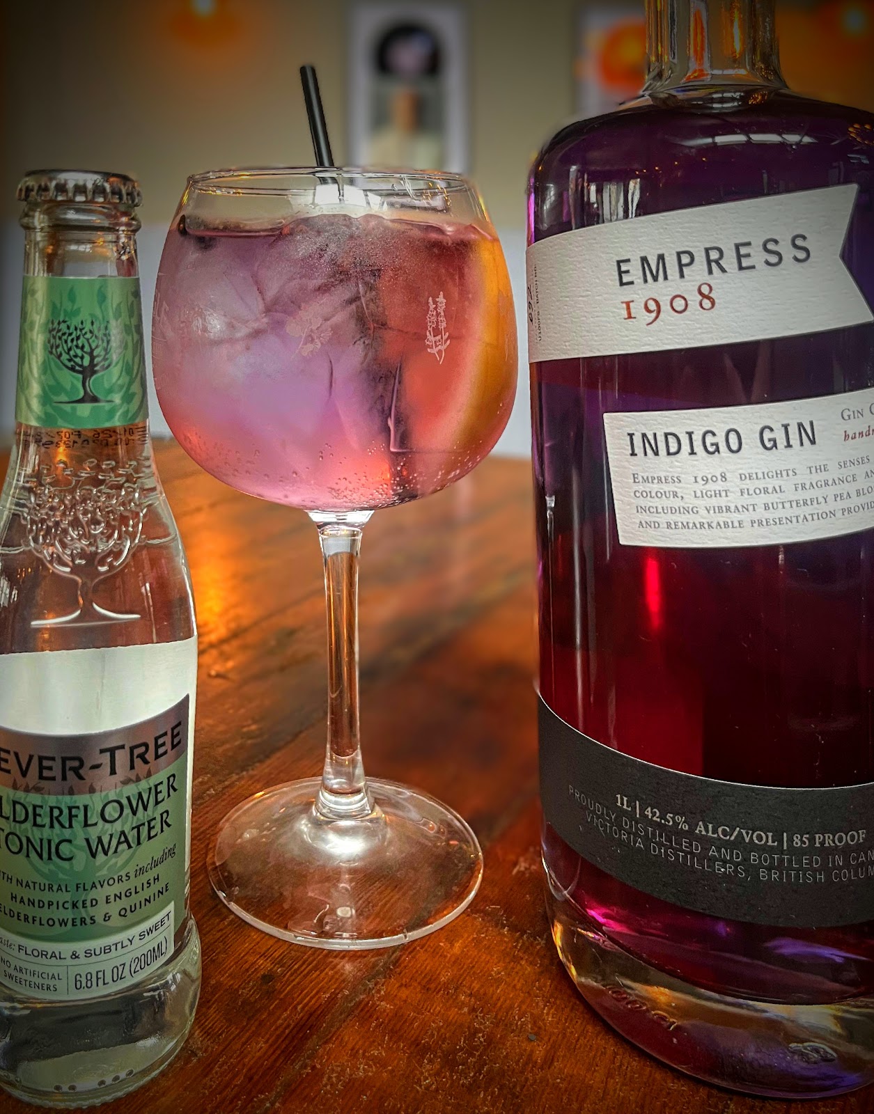 A purple-hued Empress 1908 gin cocktail in the warm interior of Pub Thirty Two