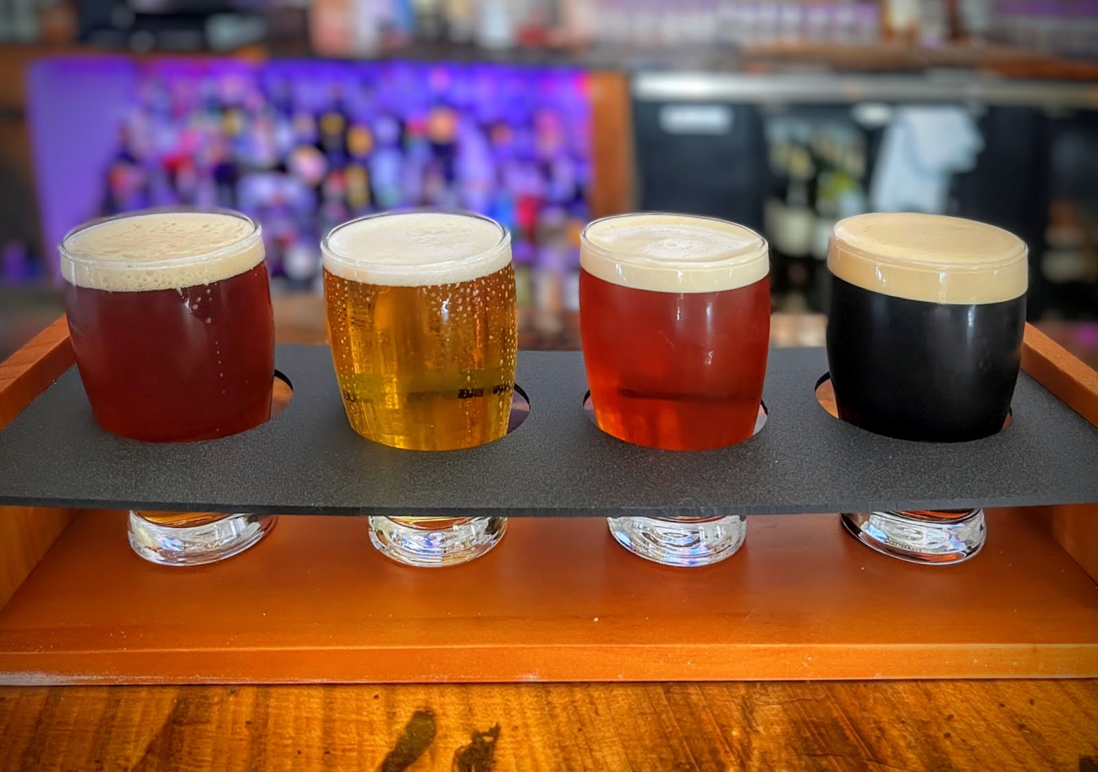 A four-glass beer flight sitting on the bar at Pub Thirty Two