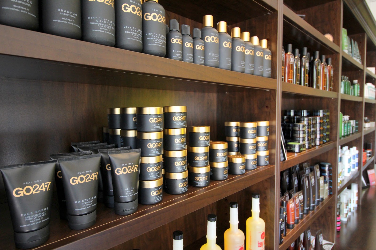 Shelves of GO247 men's grooming products at Refine Men's Salon