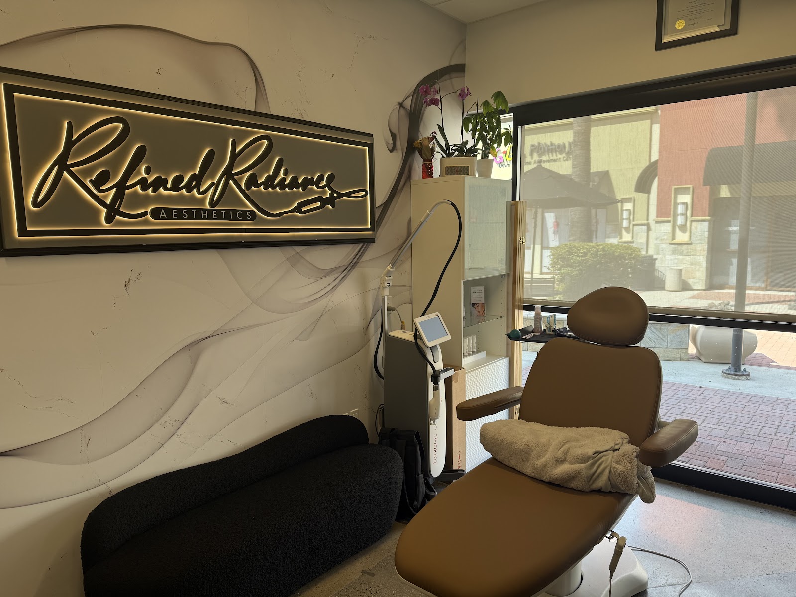 The treatment room and laser device at Refined Radiance Aesthetics in Laguna Hills