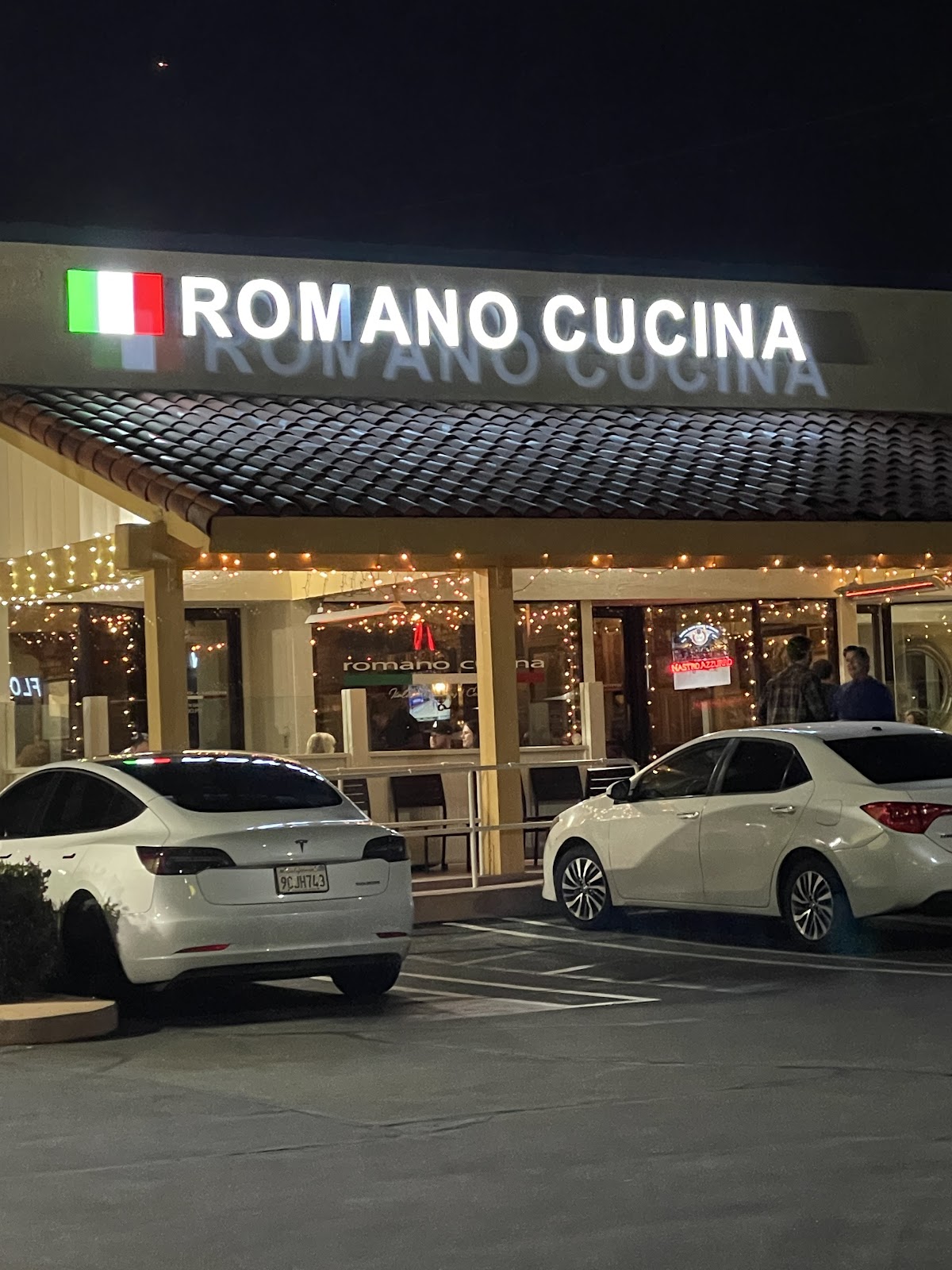 Romano Cucina storefront in the evening