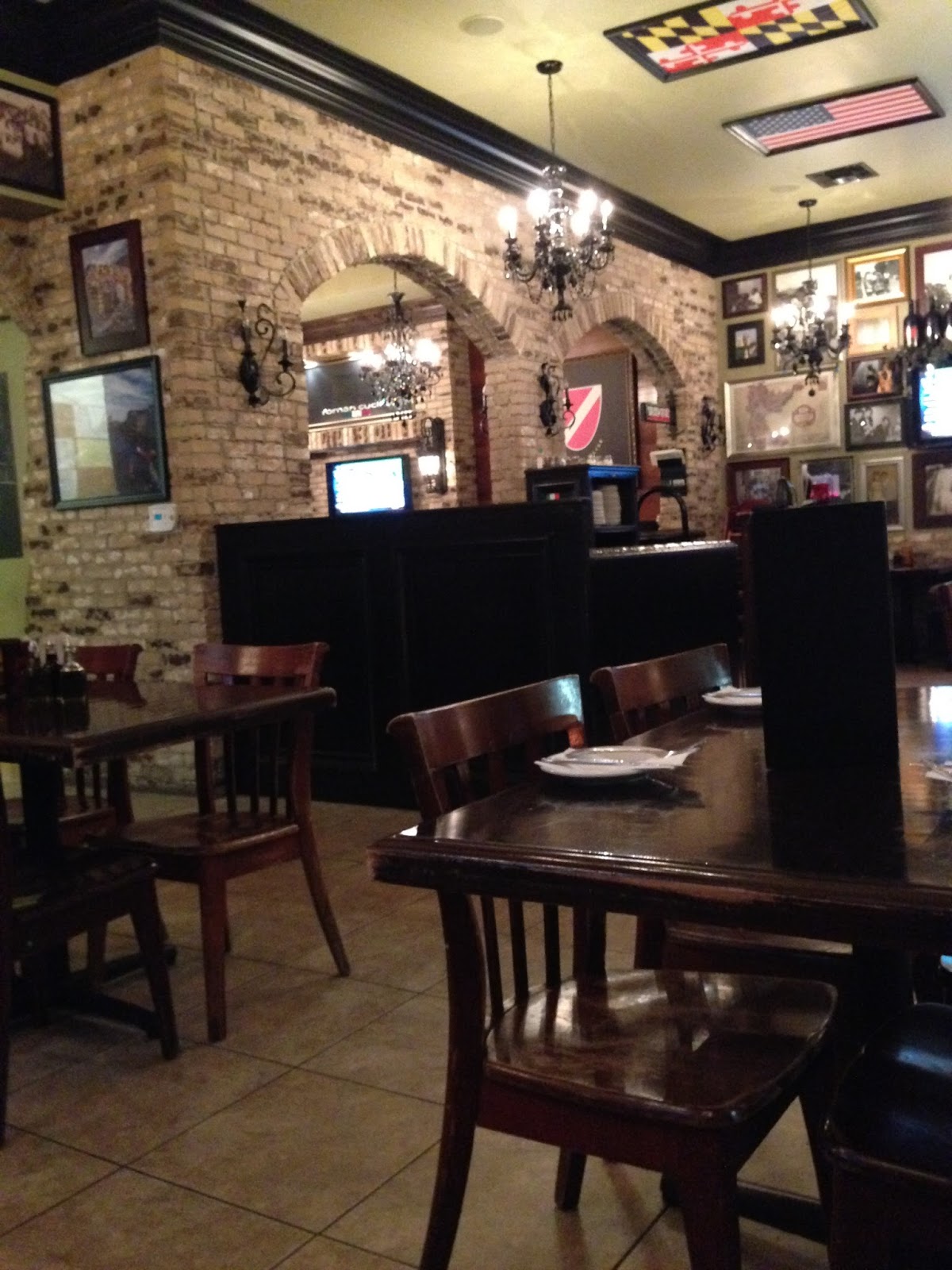 The warm brick-and-wood dining room at Romano Cucina