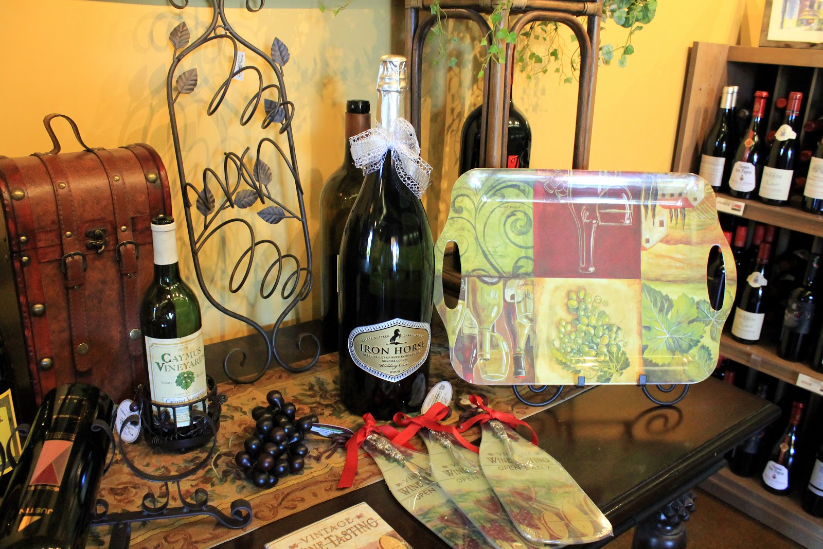 Gift display at Salt Creek Wine Company with a Caymus bottle, Iron Horse sparkling, and a wine basket