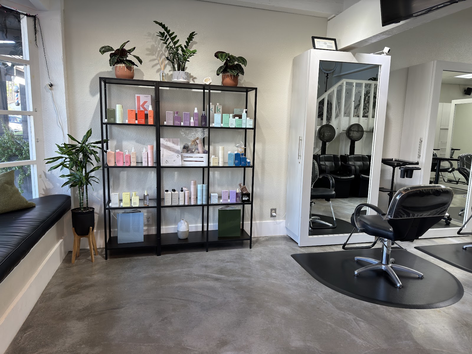 The Secrets Salon interior, with a styling chair, product shelf, and window bench