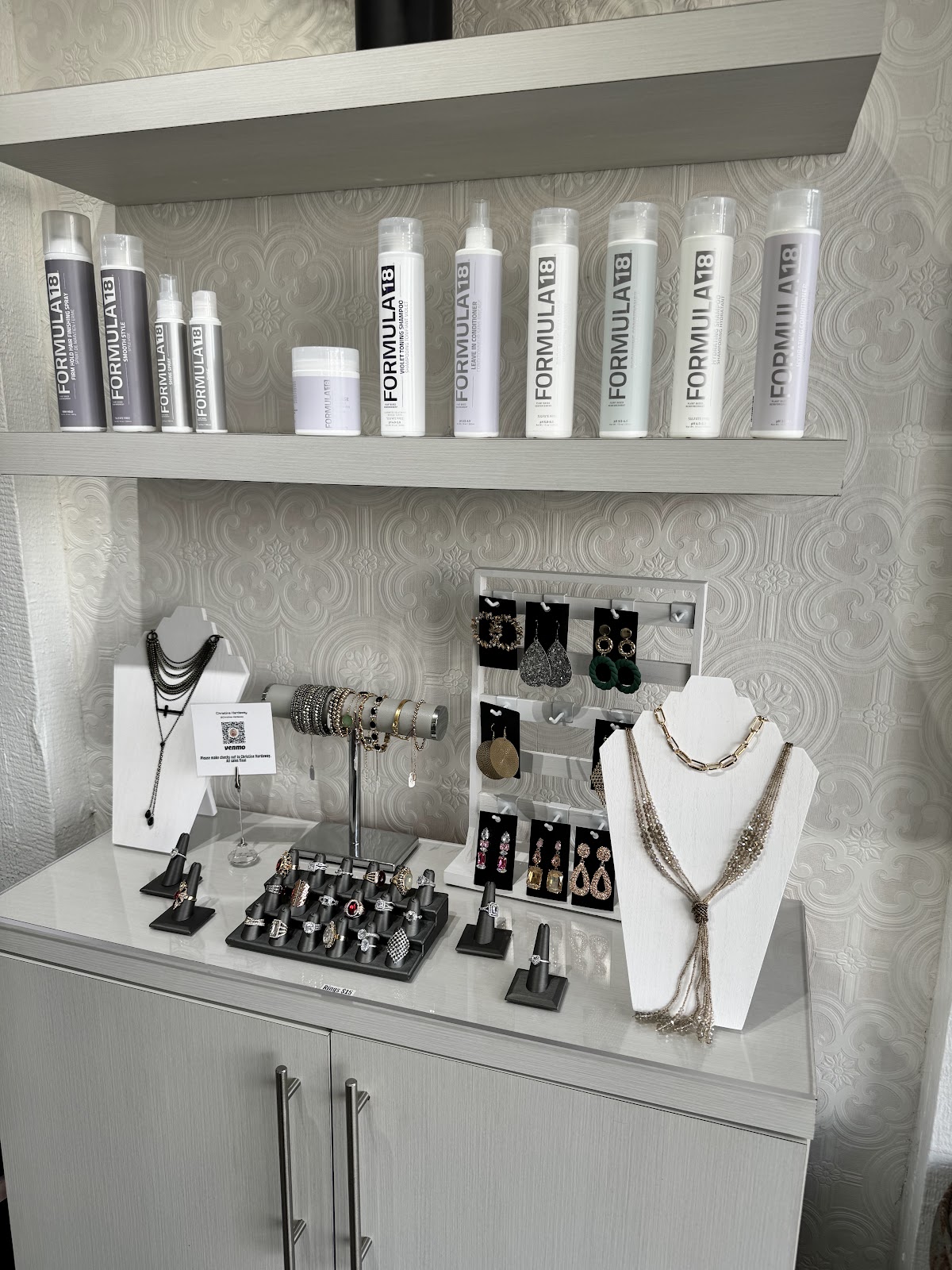 Formula 18 hair care and a jewelry display at Secrets Salon
