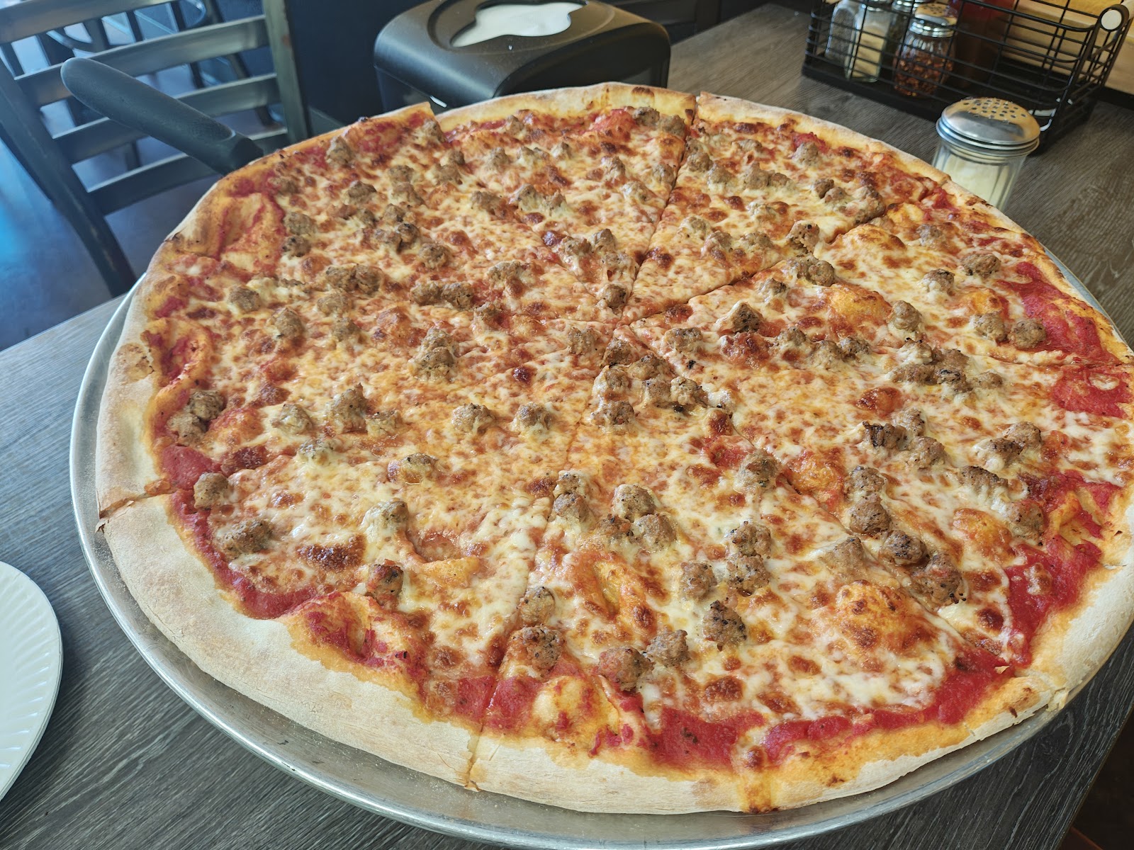 A whole Italian-sausage pizza at Terra Mia, mozzarella, tomato sauce, sausage all the way to the edge