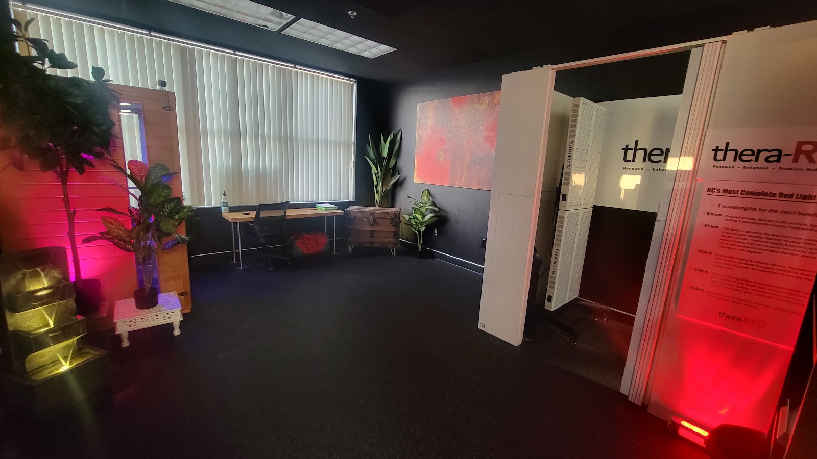 The Thera-RED lobby in Rancho Santa Margarita, with a red light booth ready and plants framing the entry