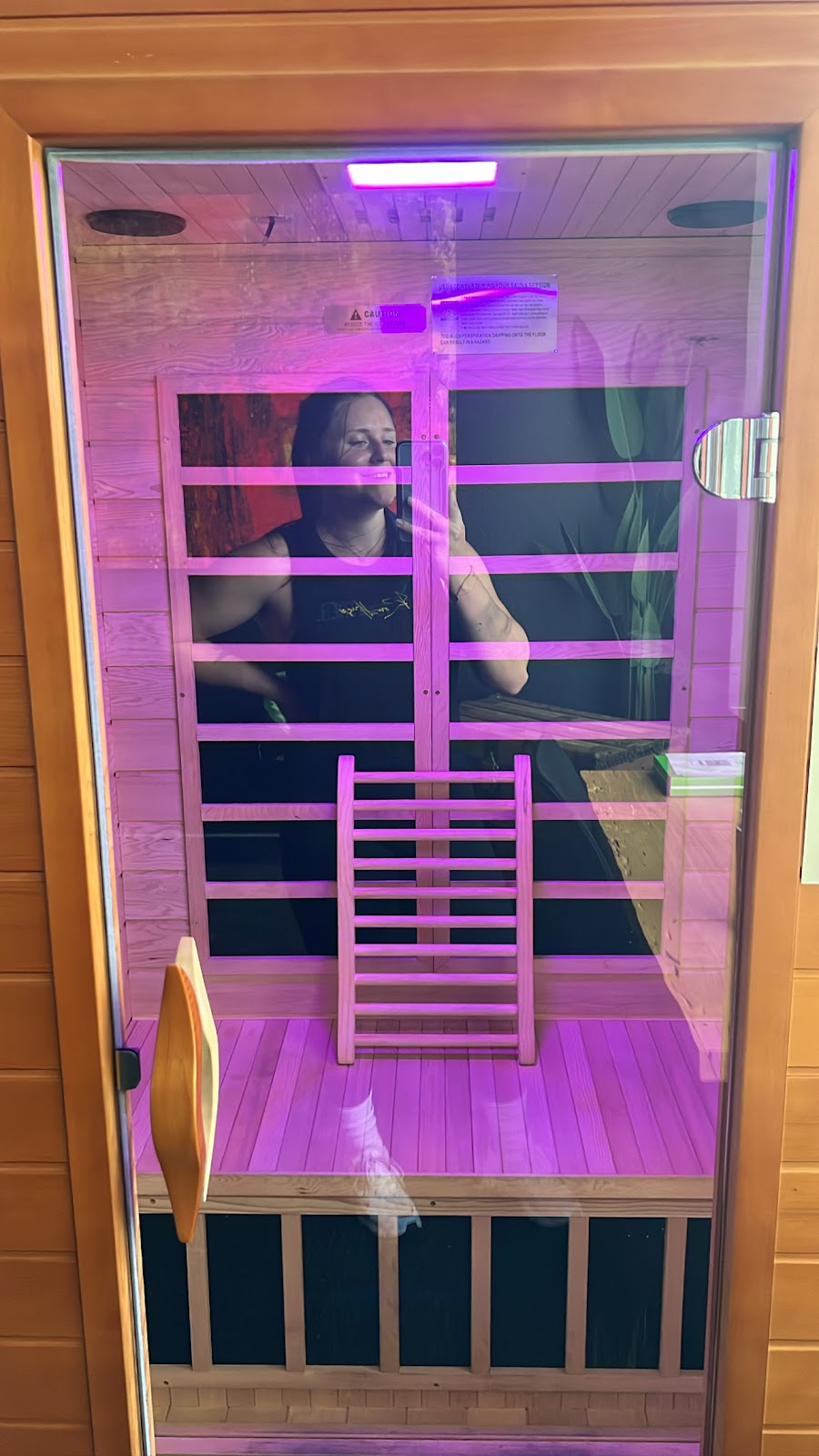 The single-person infrared cabin at Thera-RED lit with violet chromotherapy
