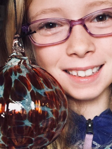 A young patient smiling in new glasses