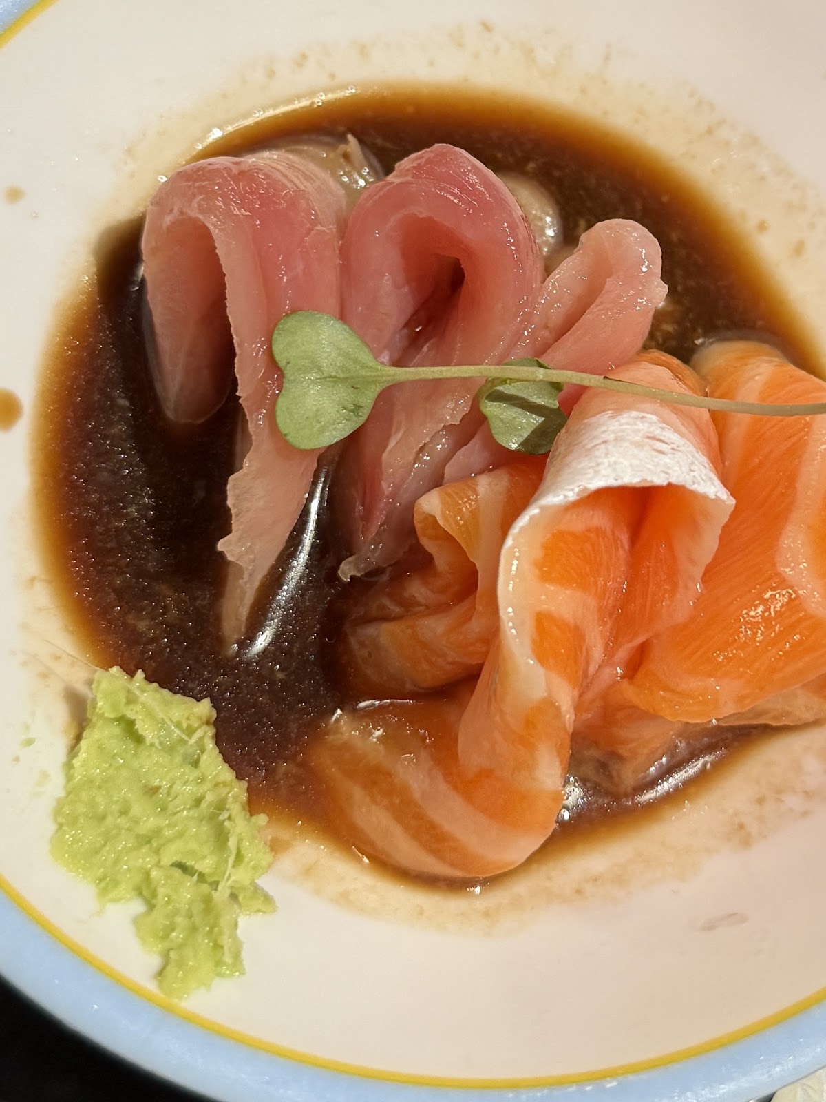 Yellowtail and salmon sashimi in ponzu with a dab of wasabi